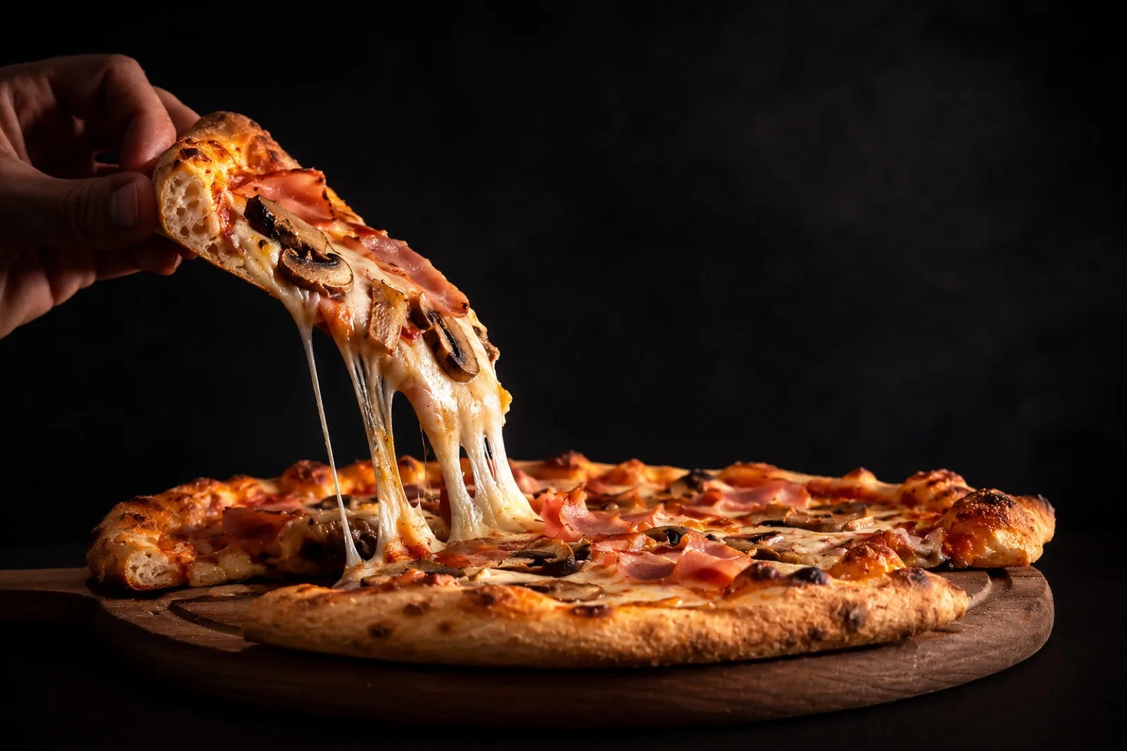 Melty cheese pull from a fresh wood-fired pizza at Vito's